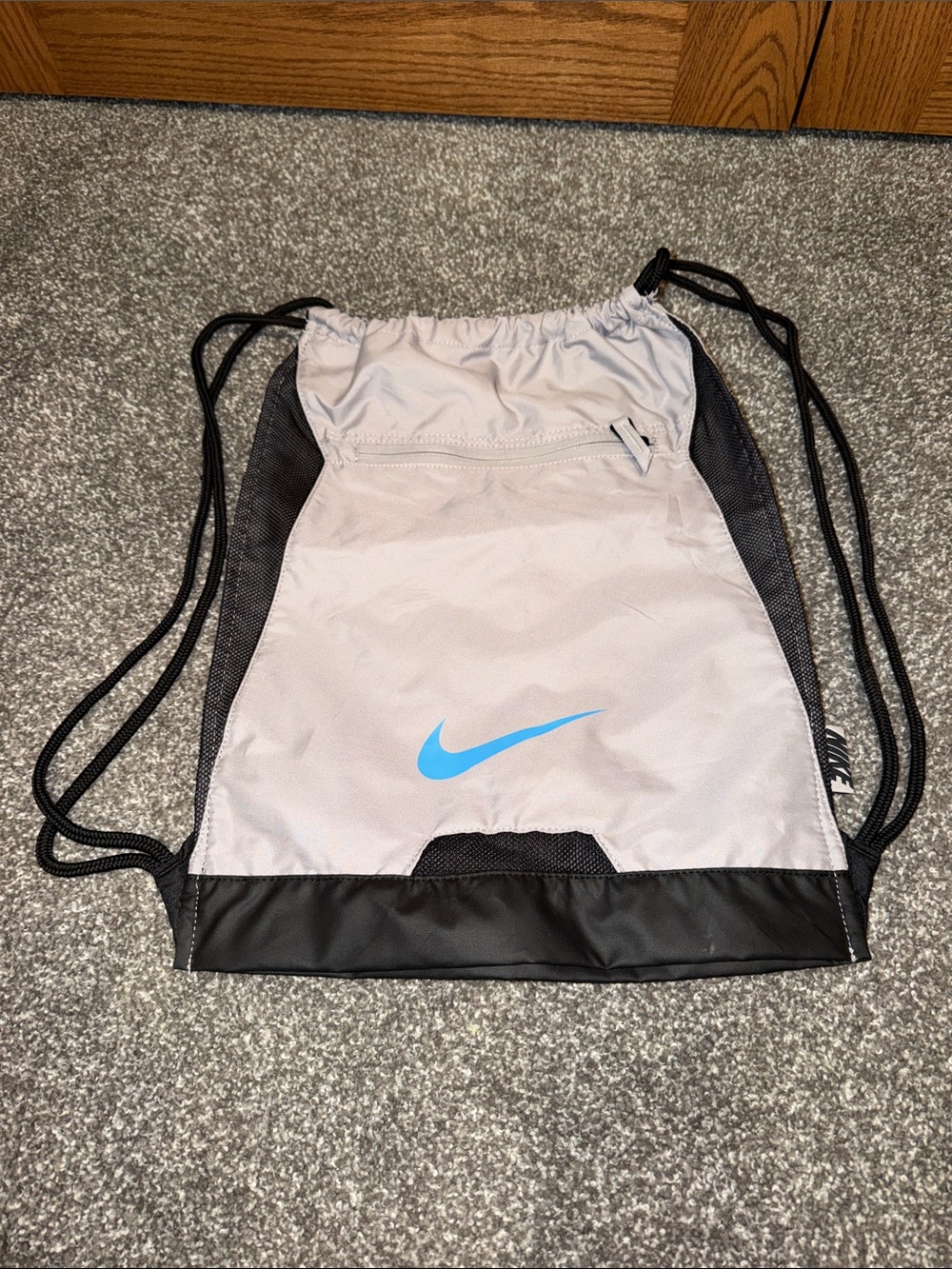 Nike Light Gray Drawstring Backpack with Blue Swoosh and Black Trim